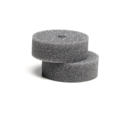 Two gray Skid Out stain eraser sponges stacked on a white background